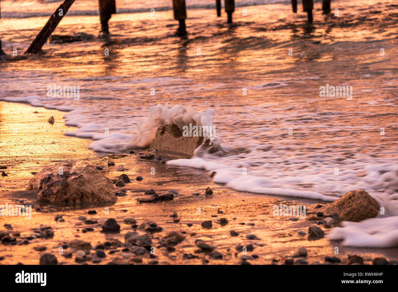 rocks on the water at Atlit beach,sunset time, Israel Stock Photo - Alamy