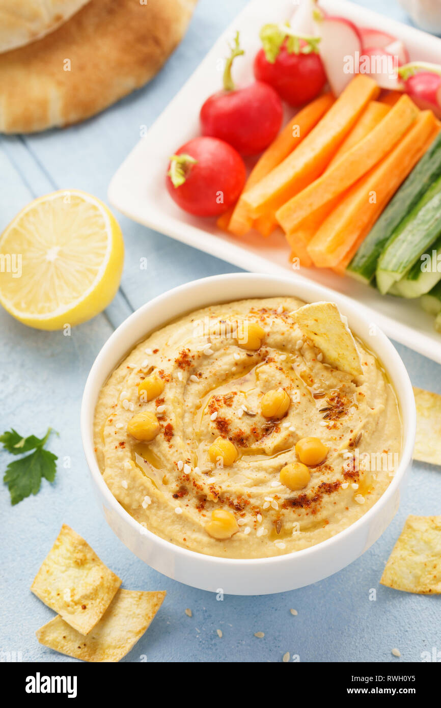 Hummus and variety of vegetable sticks and chips. Healthy snacks Stock