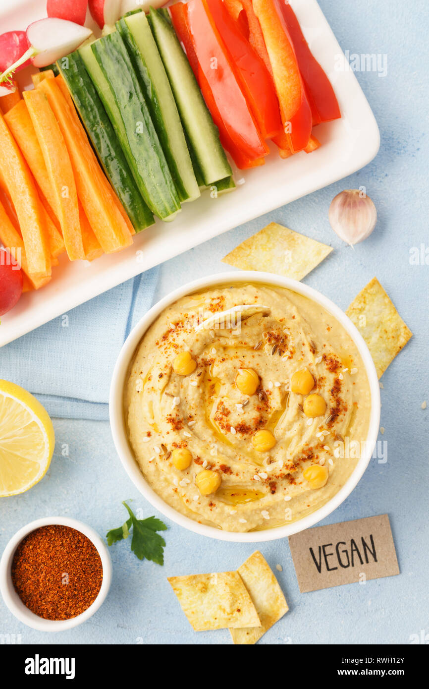 Hummus dip served with fresh vegetable sticks. Healthy vegan food Stock