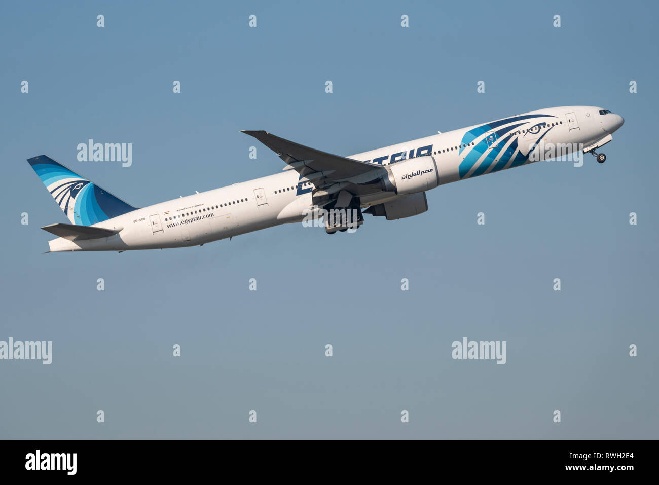 Egyptair Boeing 777 jet plane airliner SU-GDO taking off from London Heathrow Airport, UK, in blue sky Stock Photo