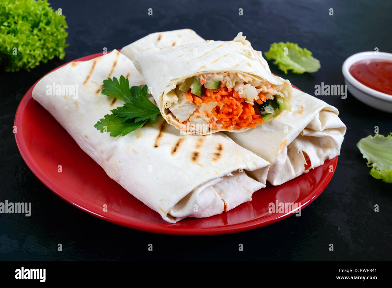 Delicious shawarma sandwich on a black background. Burritos wraps with