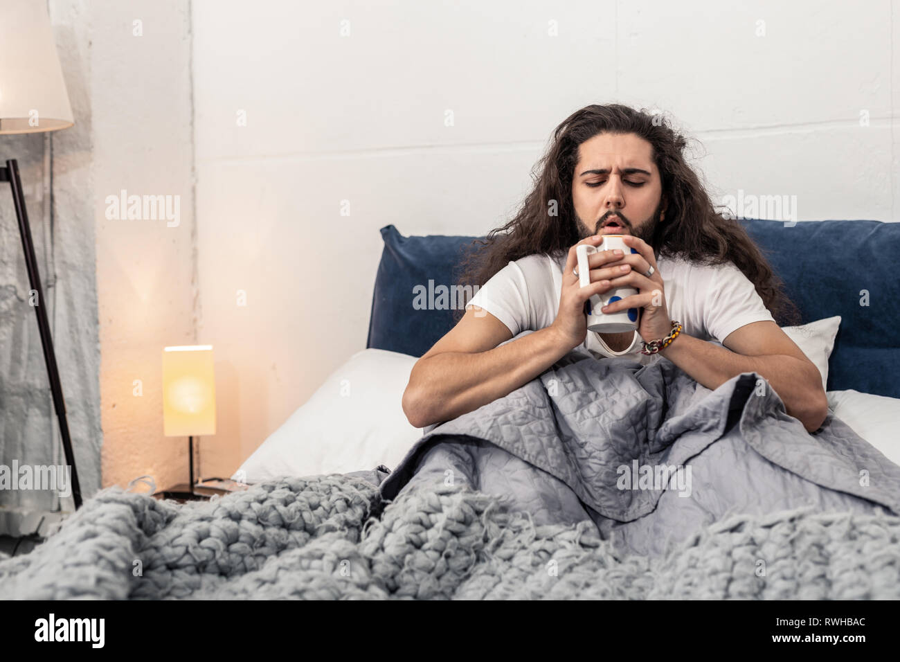 Nice handsome man blowing at the tea Stock Photo