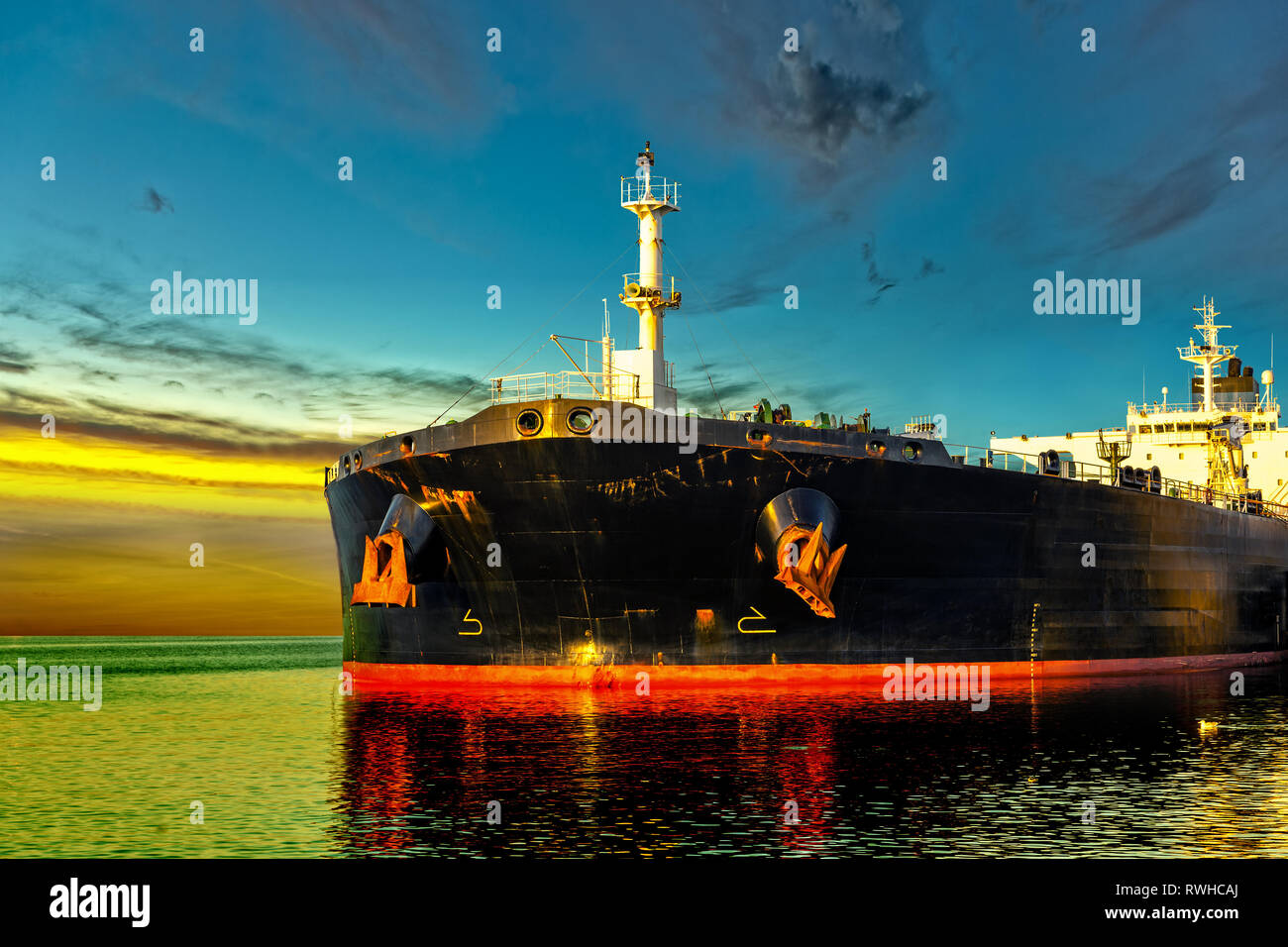 Oil Tanker in the sea at sunrise. Stock Photo