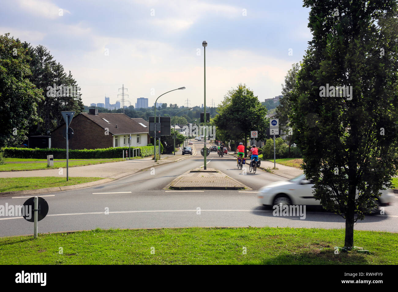 Essen, North Rhine-Westphalia, Ruhr area, Germany - Street scene with cyclists in Stoppenberg with a view towards the city centre of Essen, here on th Stock Photo