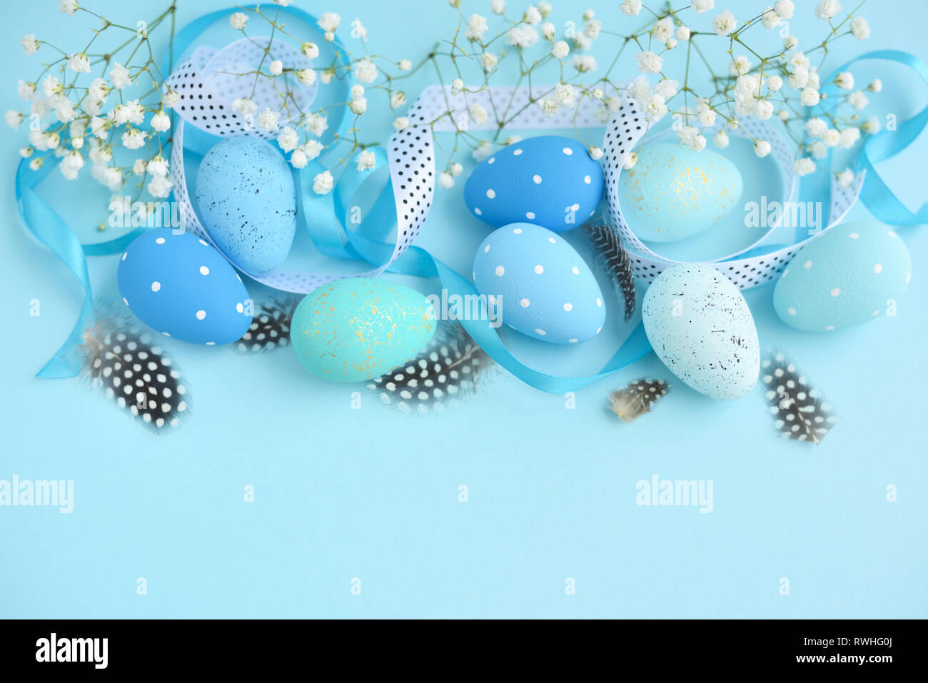 Easter eggs on a blue background. Festive easter background Stock Photo