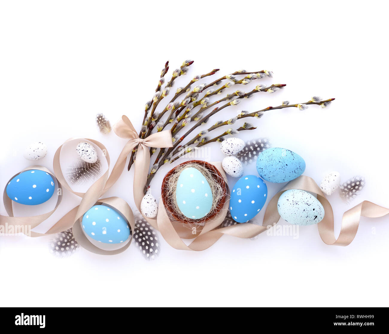 Easter eggs and willow branches on white background. Easter card. Top view Stock Photo