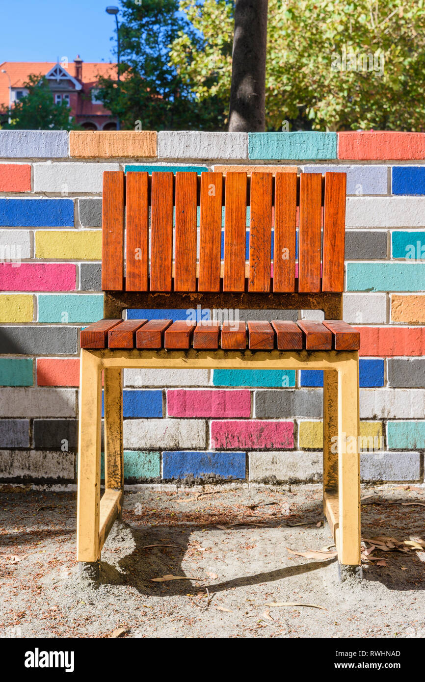 Public seating chair and colourful painted wall next to the new Hibernian Place in Perth, Western Australia Stock Photo