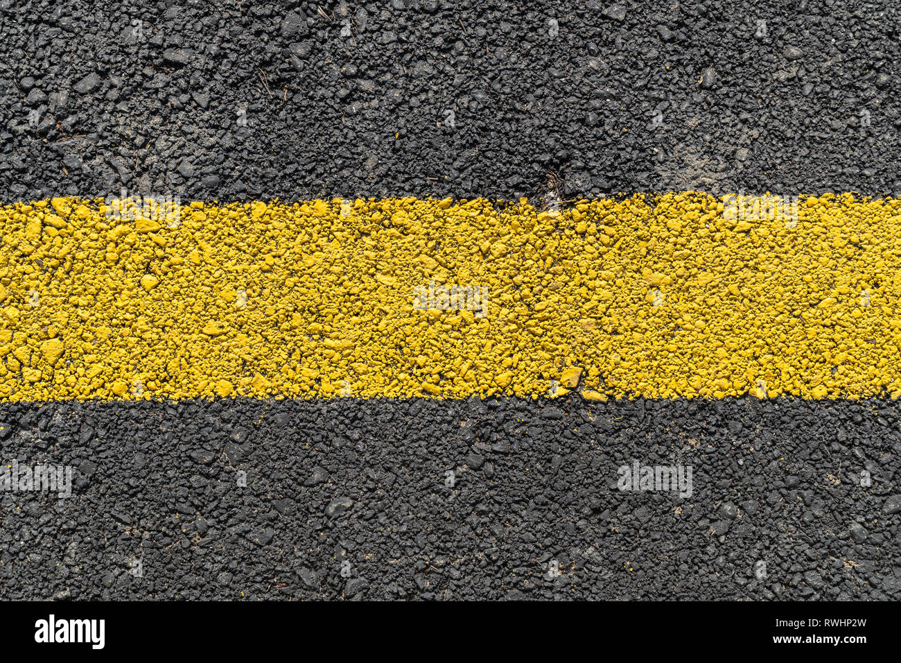 Yellow strip road markings on asphalt Stock Photo