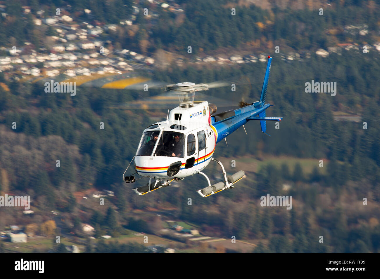 A Royal Canadian Mounted Police helicopter, a Eurocopter AS350, flies near Nanaimo, British Columbia, Canada Stock Photo