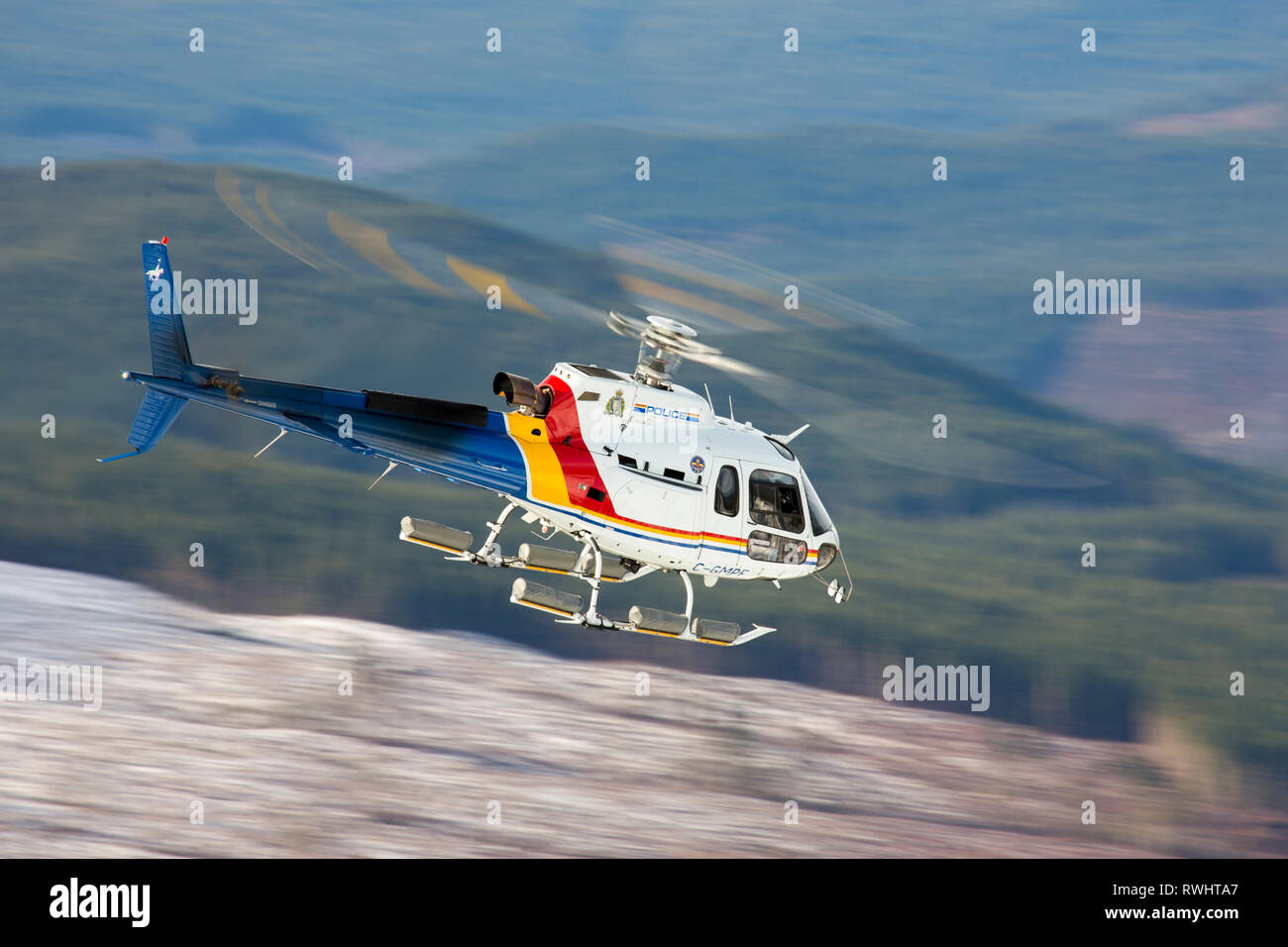 A Royal Canadian Mounted Police helicopter, a Eurocopter AS350, flies near Nanaimo, British Columbia, Canada Stock Photo