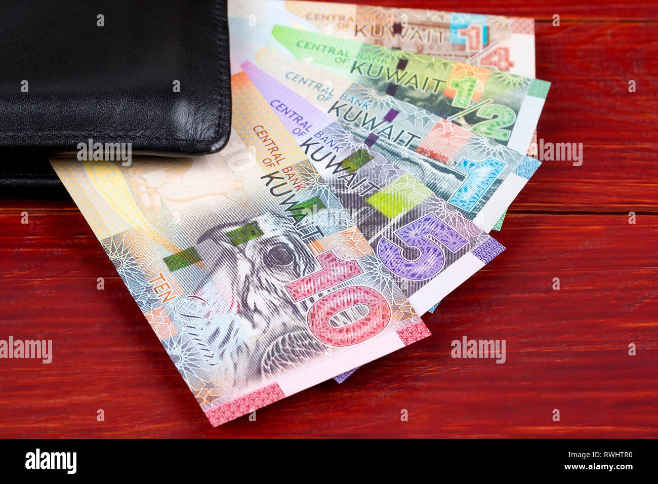 Money from Kuwait in the black wallet Stock Photo Alamy