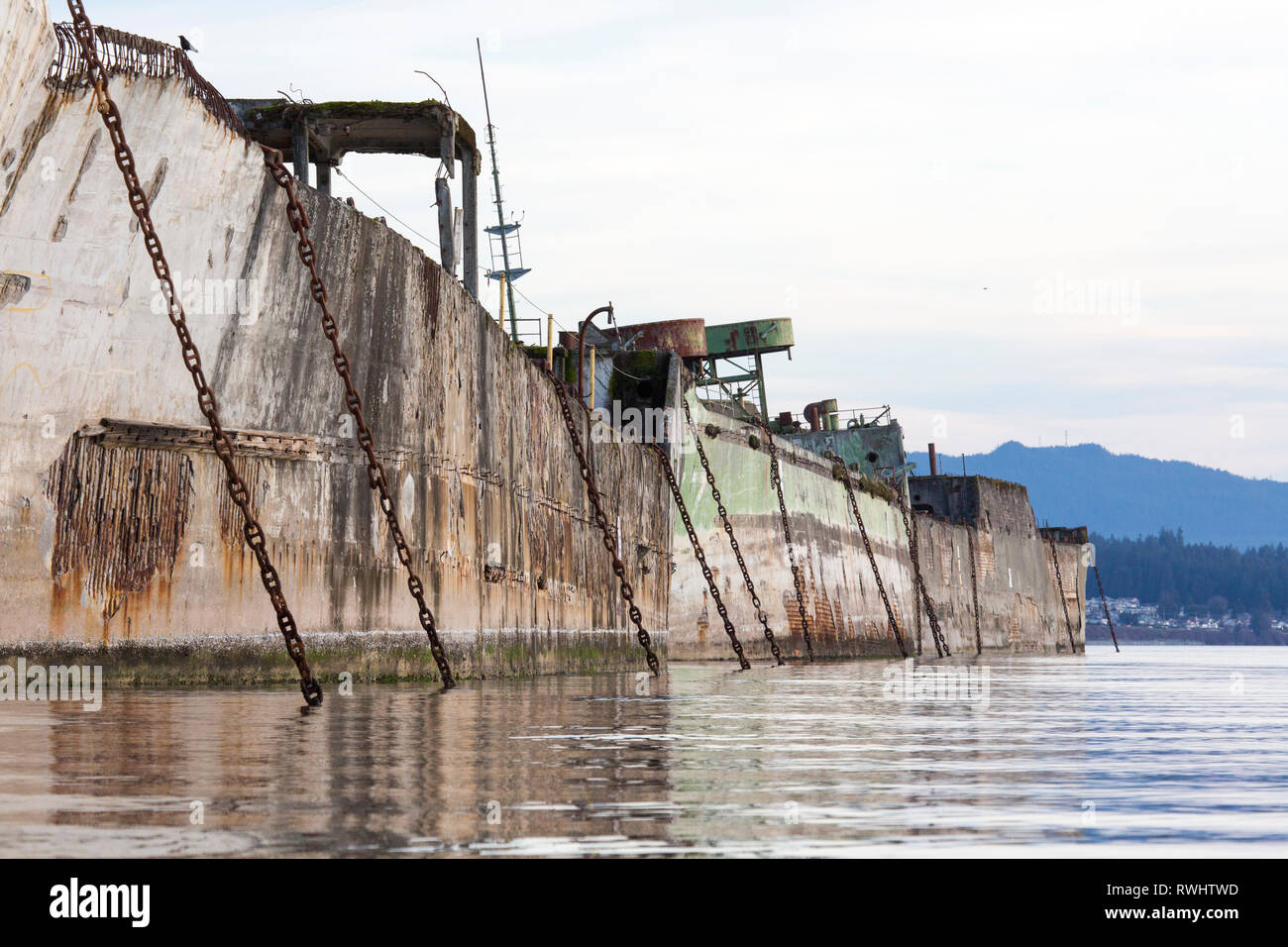 Concrete barges, used as a floating breakwater for Catalyst Paper's Mill in Powell River, British Columbia, Canada Stock Photo