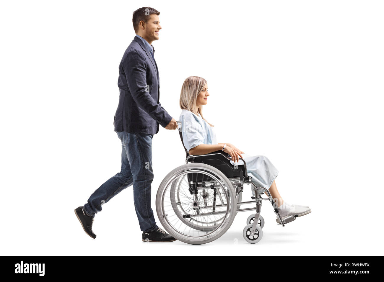 Full Length Profile Shot Of A Young Man Pushing A Young Woman In A ...