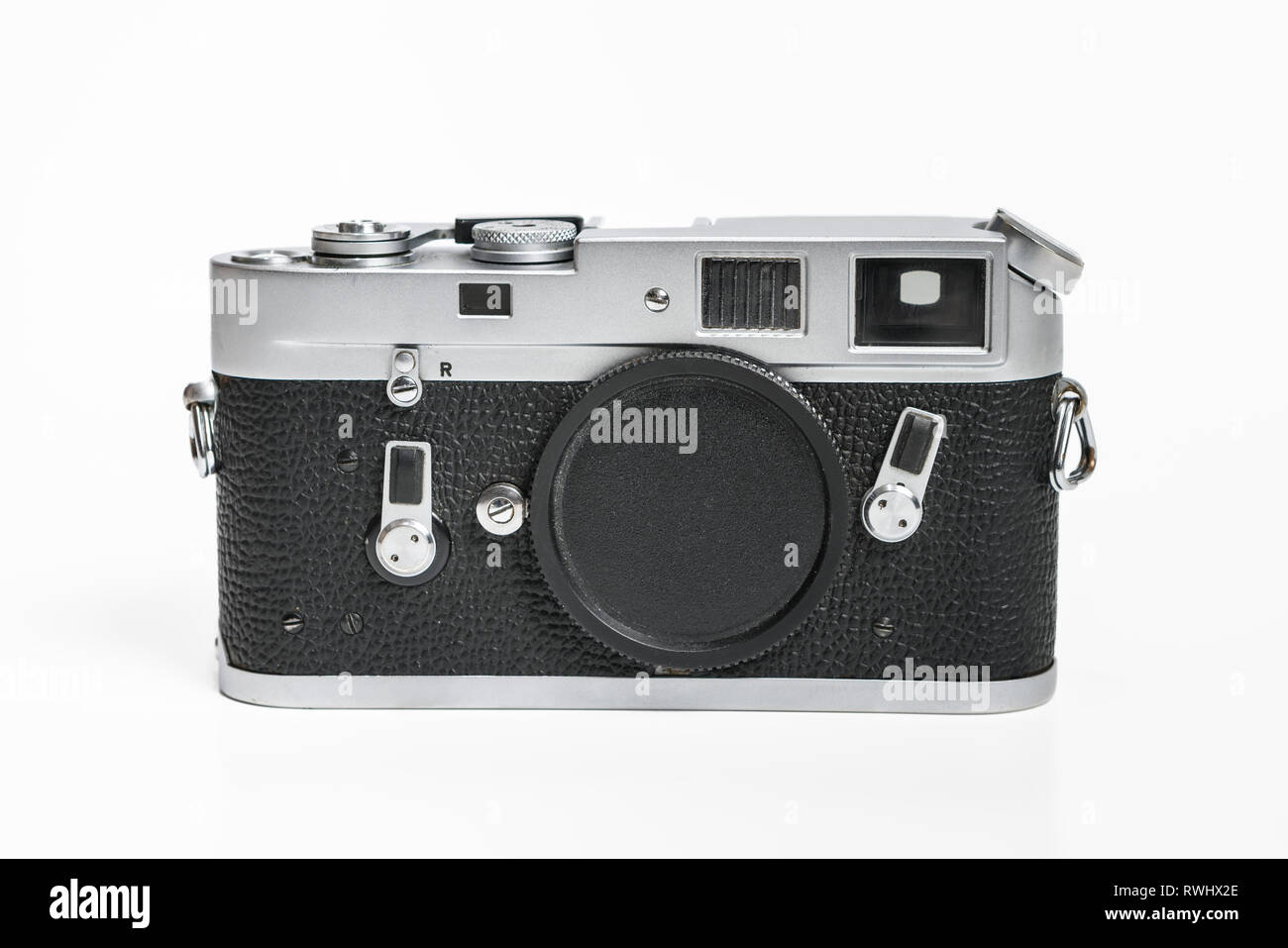 Leitz Leica M4 from 1967, vintage analog film camera. Body only with no lens on white studio background. Logo and branding removed from image. Stock Photo