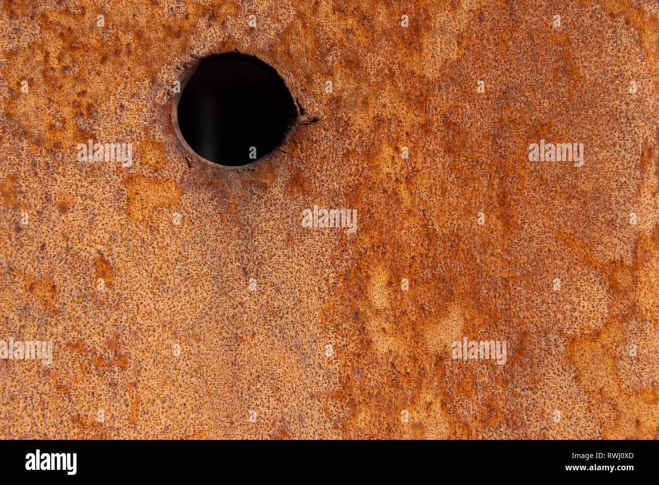 Old Distressed Brown Terracotta Copper Rusty Stone Background with Rough Texture Multicolored Inclusions. Stained Gradient Coarse Grainy Surface Stock Photo