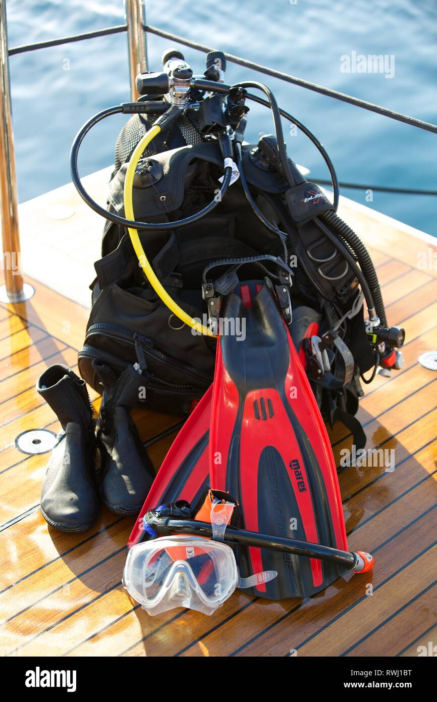 Diving equipment - tank, respirator, oxygen gauge and flippers on boat deck at sea Stock Photo