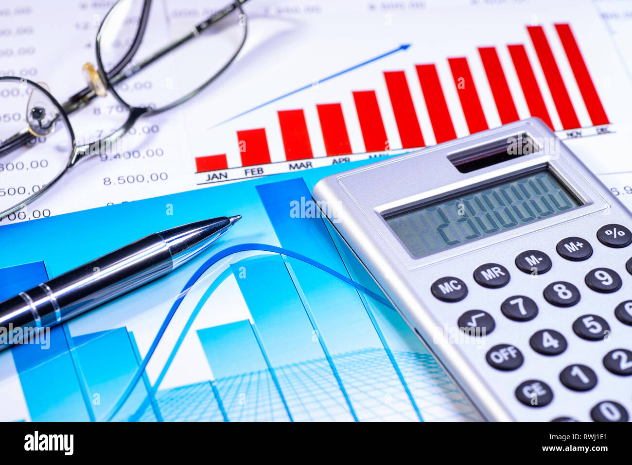 Charts and tables with calculator and pen Stock Photo Alamy