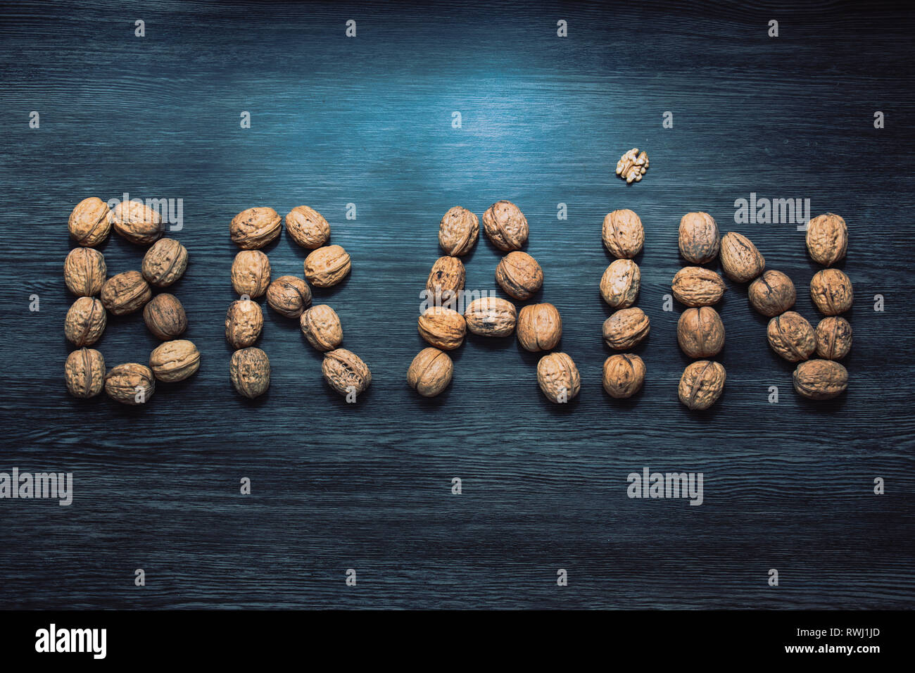 Brain letters sign made with walnuts against blue background. Brain health concept nutrition Stock Photo