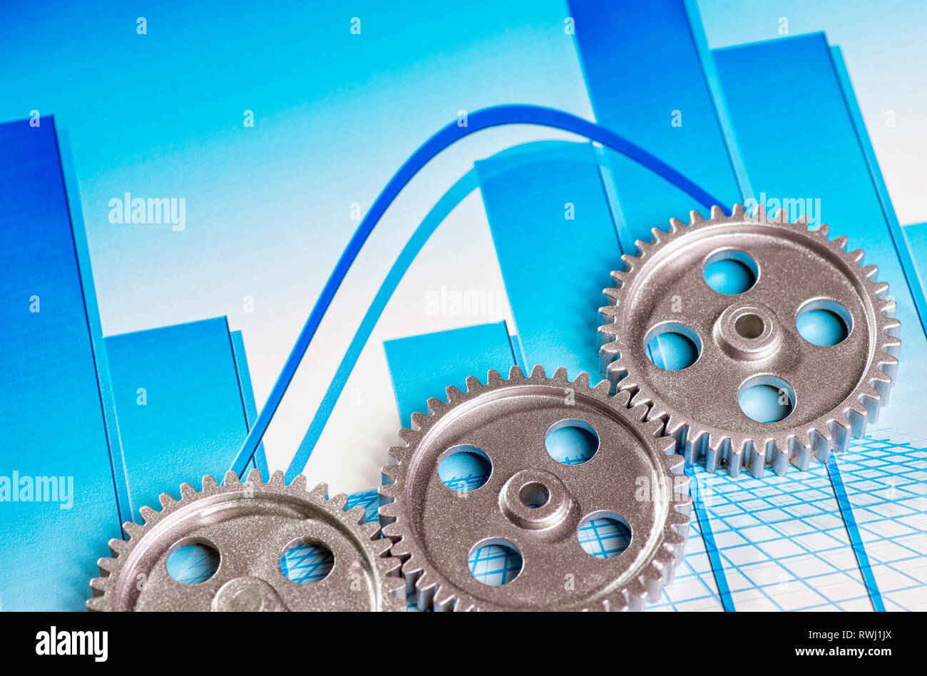 Three silver-colored gears with bar chart Stock Photo