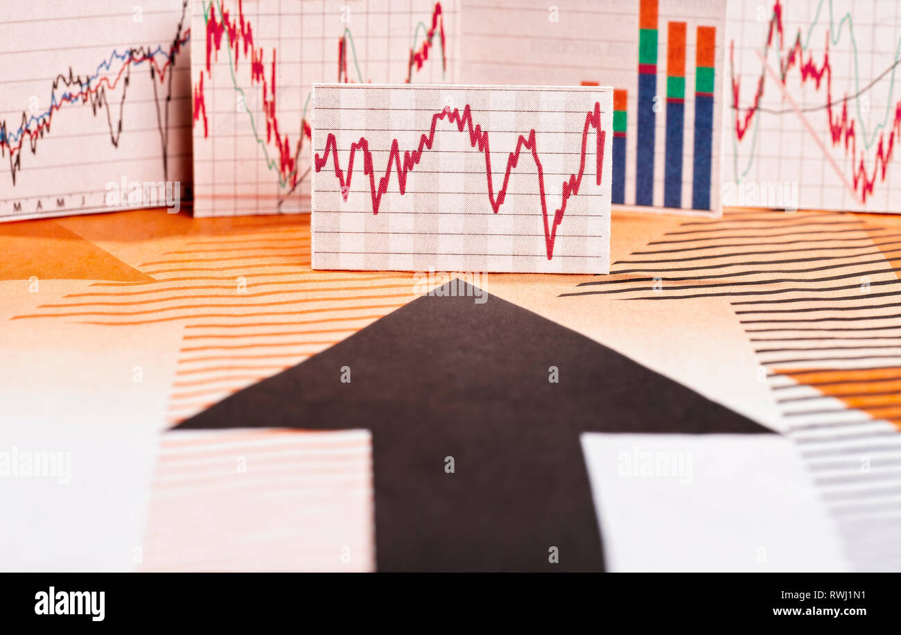 Black arrow points to different charts with stock market prices Stock Photo