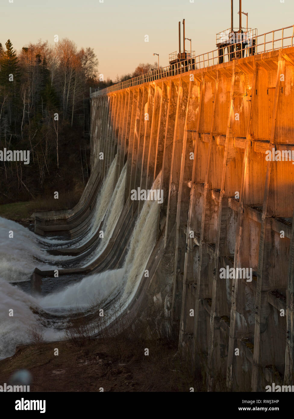 The Main Dam Spilling Water at Sunset, Deer Lake, Newfoundland and Labrador Stock Photo