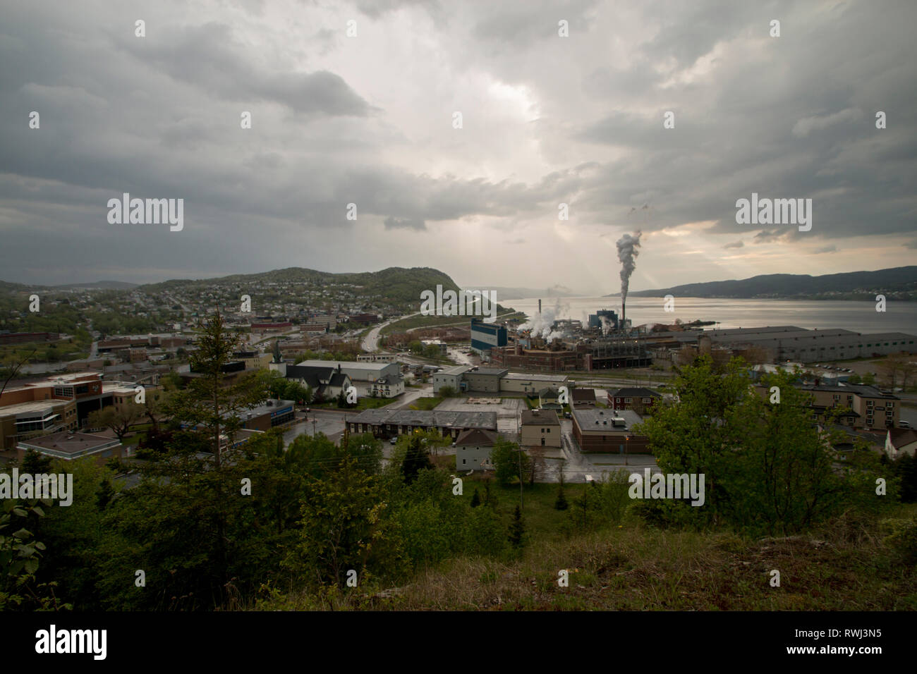 Sun Rays Breaking through the clouds on rainy day, Corner Brook, Newfoudland and Labrador Stock Photo