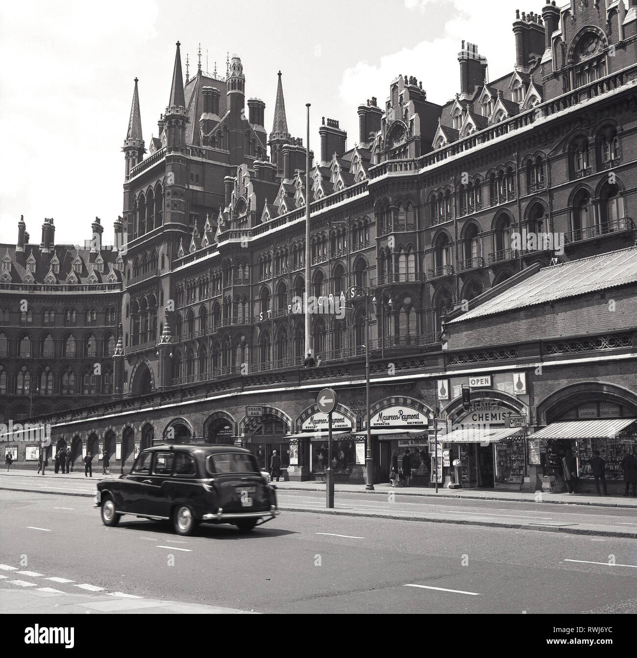 1960s, a London taxi on the Euston road going pass the Midland Grand Hotel, the frontispiece to St Pancras railway station which opened in 1868. Designed by George Gilbert Scott, the Victorian hotel opened in 1873 but closed in 1935 and was used as railway offices during this era. Stock Photo