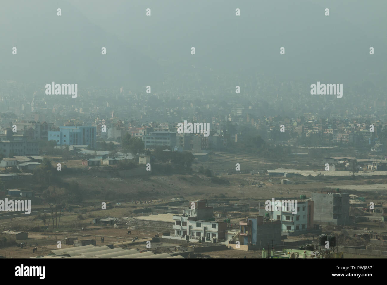 Heavy pollution and smog hang in the air over Kathmandu valley, Nepal, causing health concerns for locals and tourists alike. Stock Photo