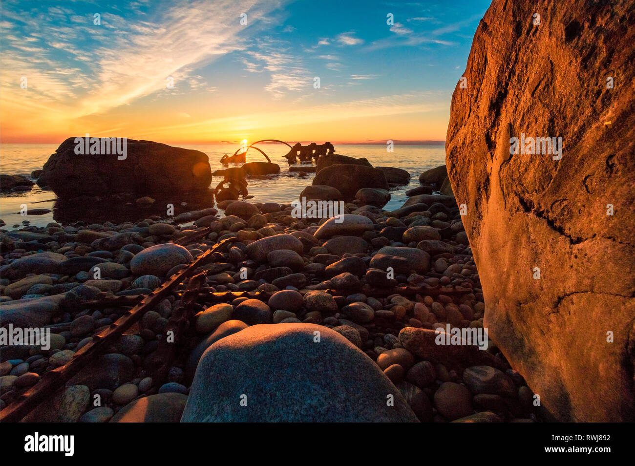 Sunsetting over the gulf of St. Lawerence at the site of the century old ship wreck of th s.s. Ethie, Gros Morne National Park, Newfoundland and Labrador Stock Photo