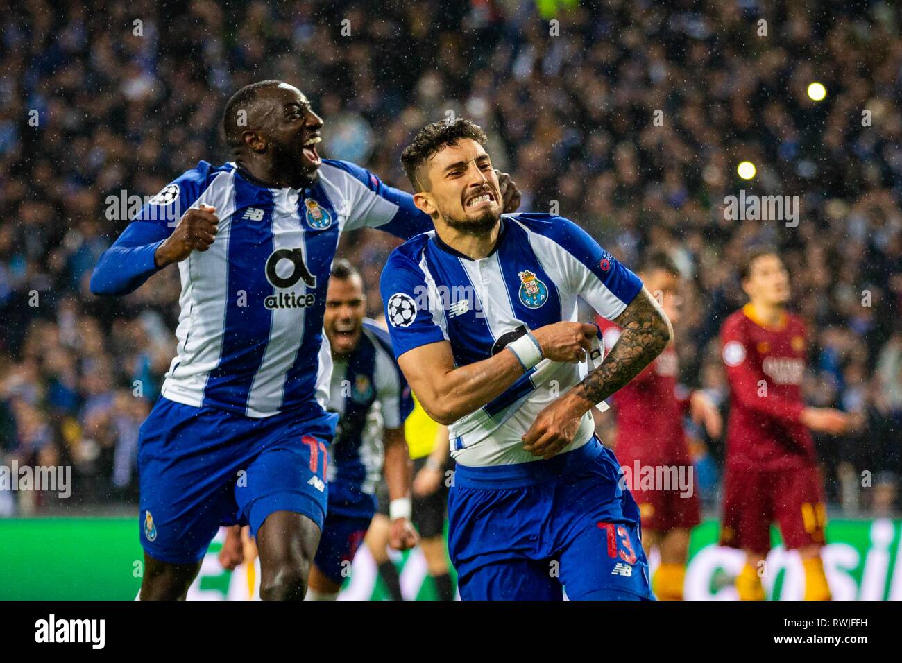 FC Porto's players Alex Telles (R) and Moussa Marega (L) celebrates the  third goal during the match against AS Roma for the UEFA Champions League  round 16th 2nd leg at Dragon Stadium
