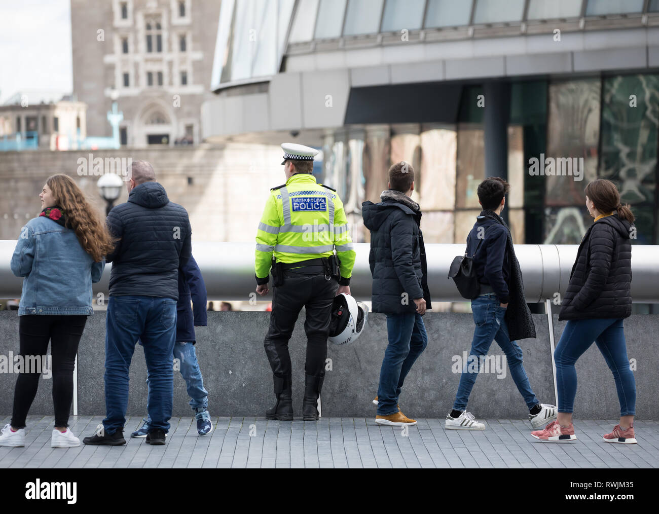 London, UK. 7th Mar, 2019. People walk along the Queenswalk,including a police officer, in London enjoying the sunshine and River views. Strong winds are forecast for this afternoon in London again. Credit: Keith Larby/Alamy Live News Stock Photo