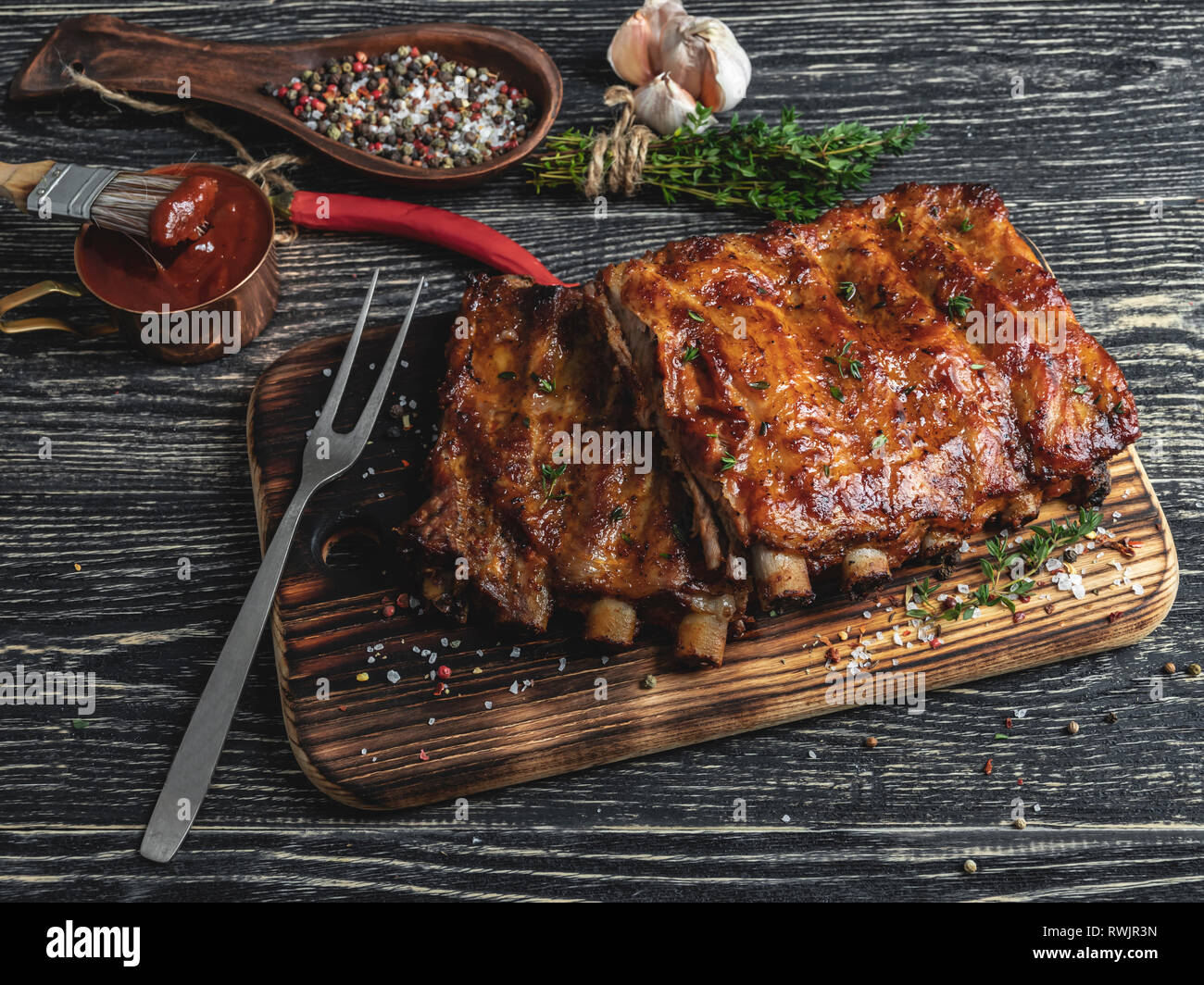 grilled pork ribs with sauce on a cutting board , spice, marinade Stock Photo