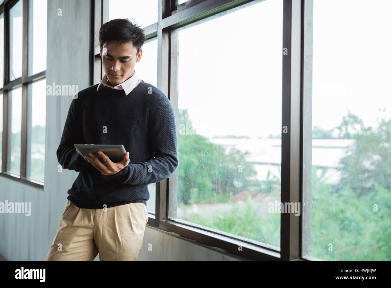 young asian businessman using tablet Stock Photo