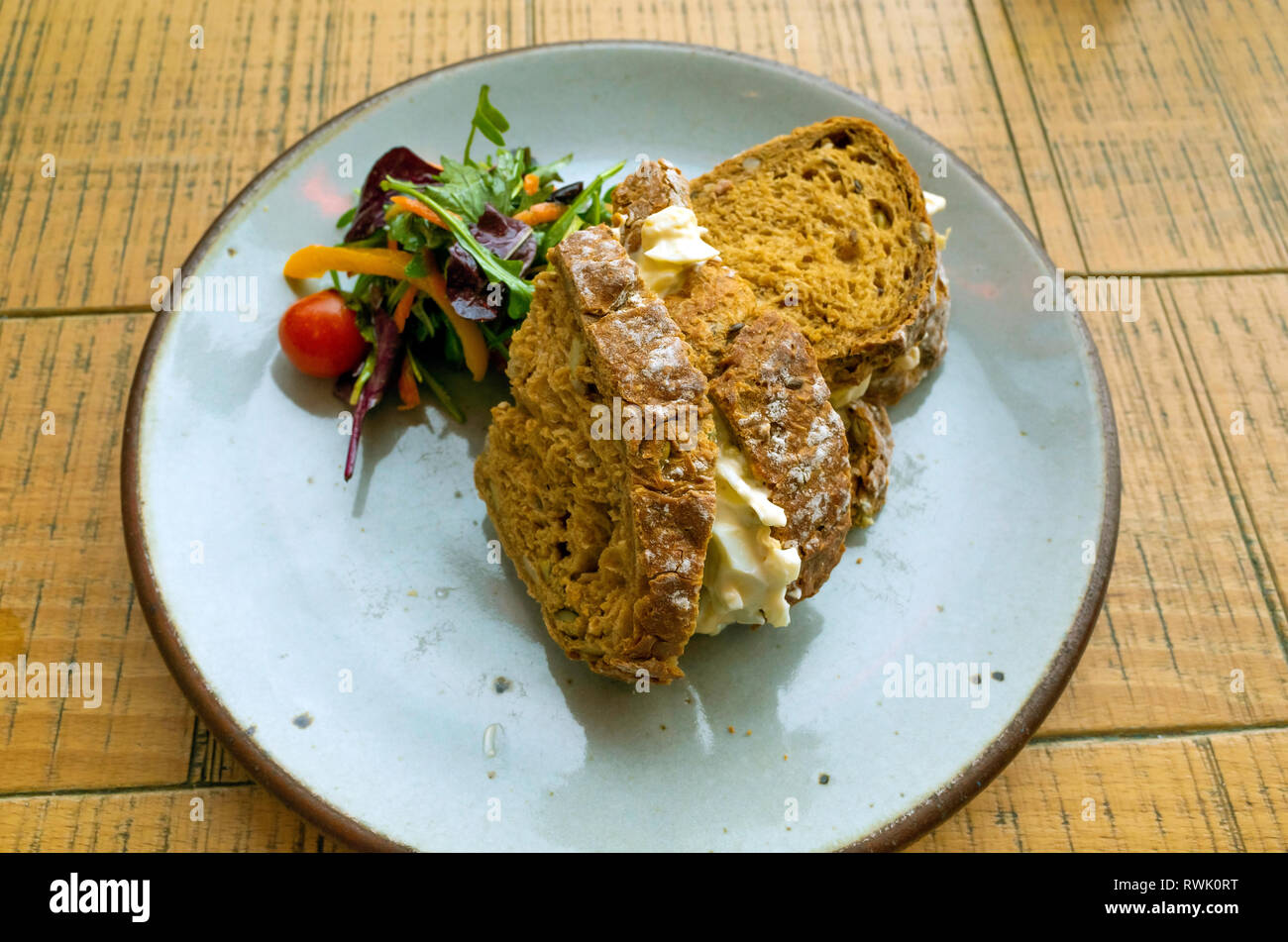 Lunchtime snack Egg Mayonnaise sandwich on brown bread with salad garnish Stock Photo Alamy