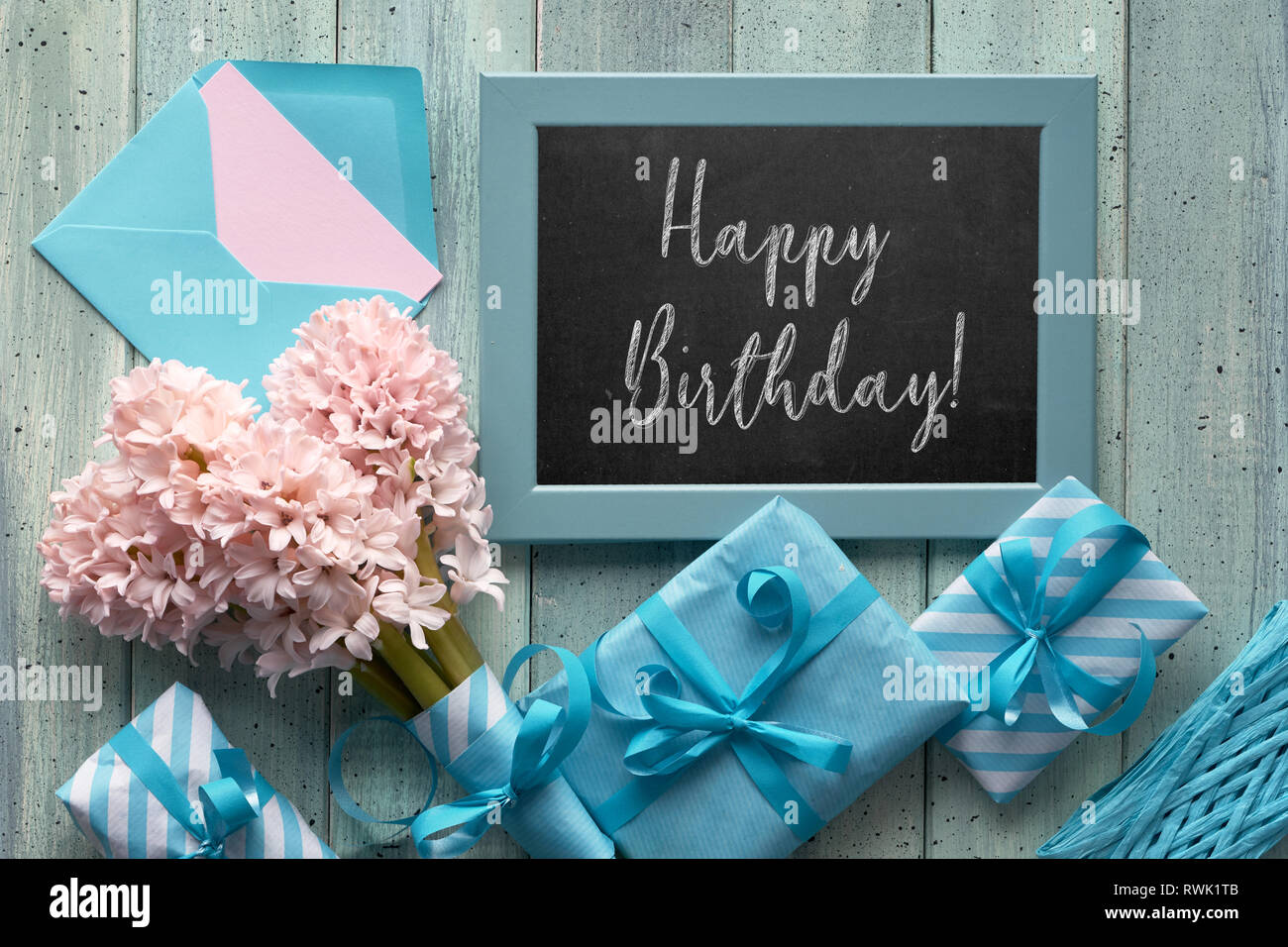 Springtime green and blue background. Chalk board with pink hyacinth