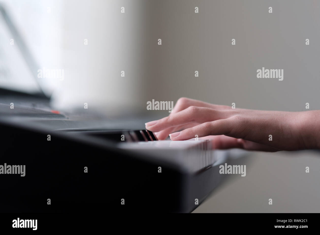 Little girl hand playing piano keyboard Stock Photo Alamy