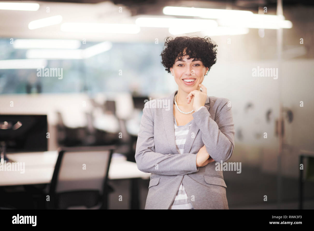 Portrait of successful female software developer with a curly hairstyle at modern startup office Stock Photo - Alamy Portrait of successful female software developer with a curly hairstyle at modern startup office Stock Photo - Alamy