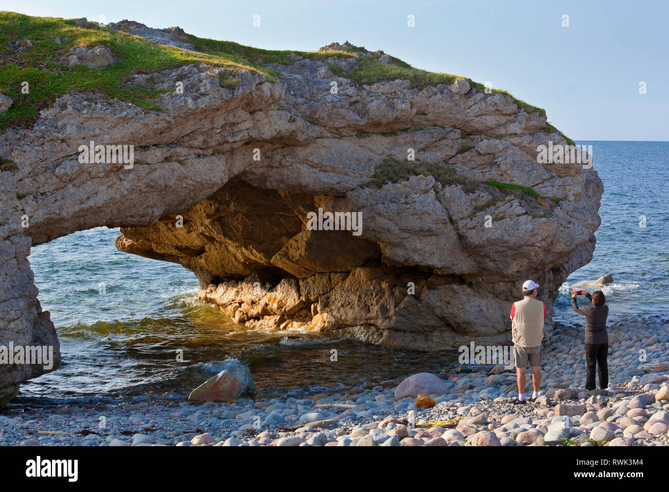 One of three archways carved out of a limestone rock formation by the pounding of the surf and accessible by foot at low tide. North of Parson's Pond, Western Newfoundland, Canada Stock Photo