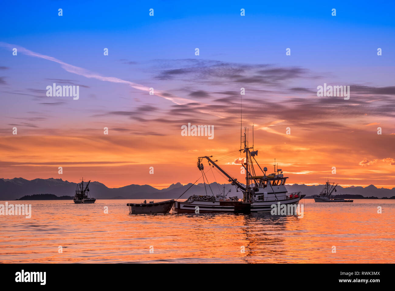 Seiners anchored in Amalga Harbor at sunset awaiting a commercial salmon opening; Juneau, Alaska, United States of America Stock Photo