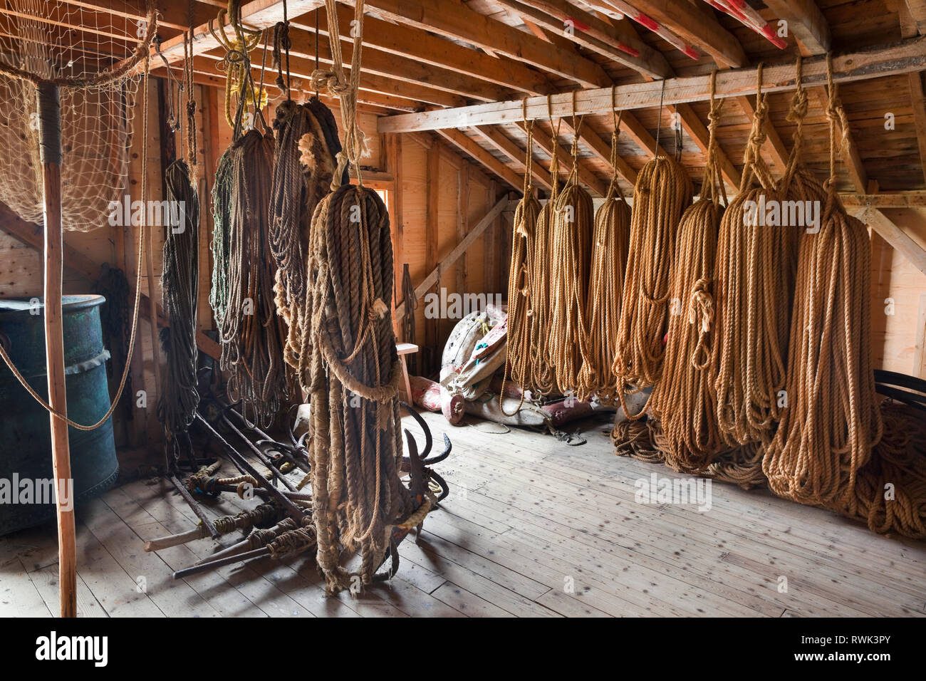 Roping, anchors and other fishing gear stored in a fishing shed at Broom Point Fishing Premises, Gros Morne National Park, Parks Canada, Western Newfoundland, Canada Stock Photo