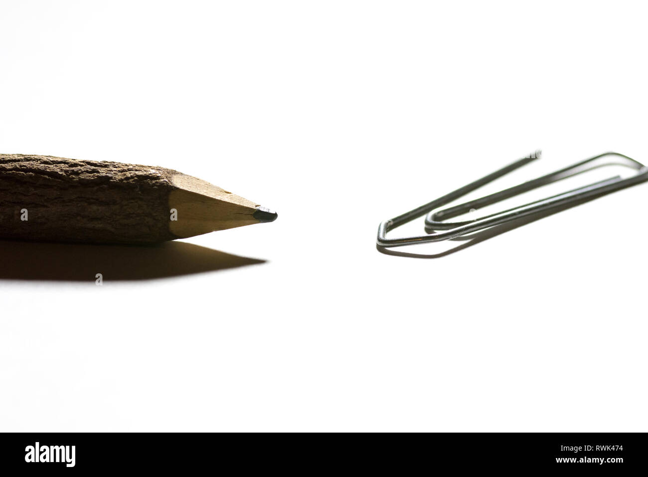 single paper clip with wooden pencil in white background Stock Photo ...