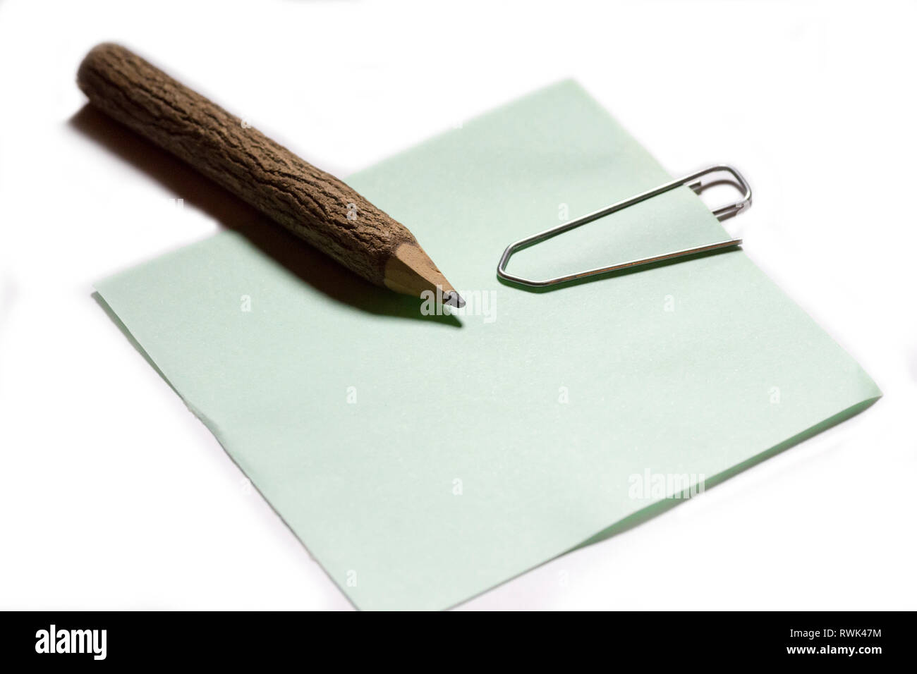 single paper clip with wooden pencil in white background Stock Photo ...