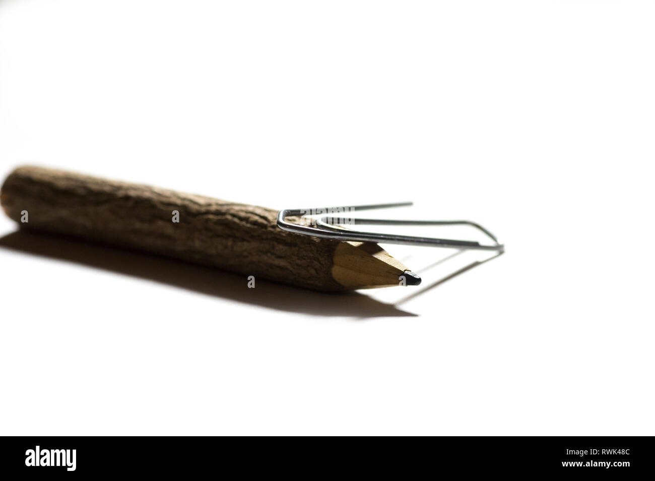 single paper clip with wooden pencil in white background Stock Photo ...