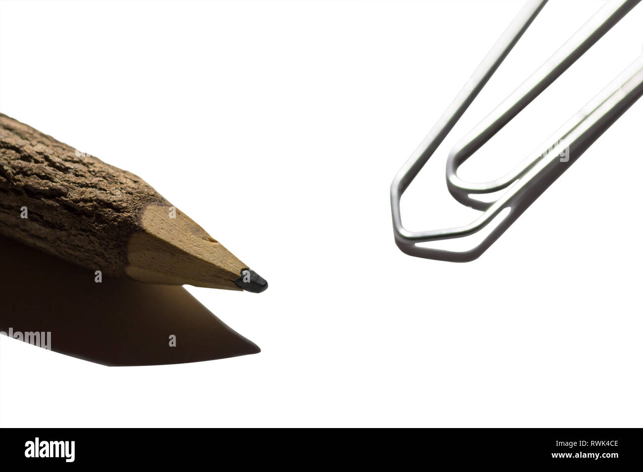 single paper clip with wooden pencil in white background Stock Photo ...