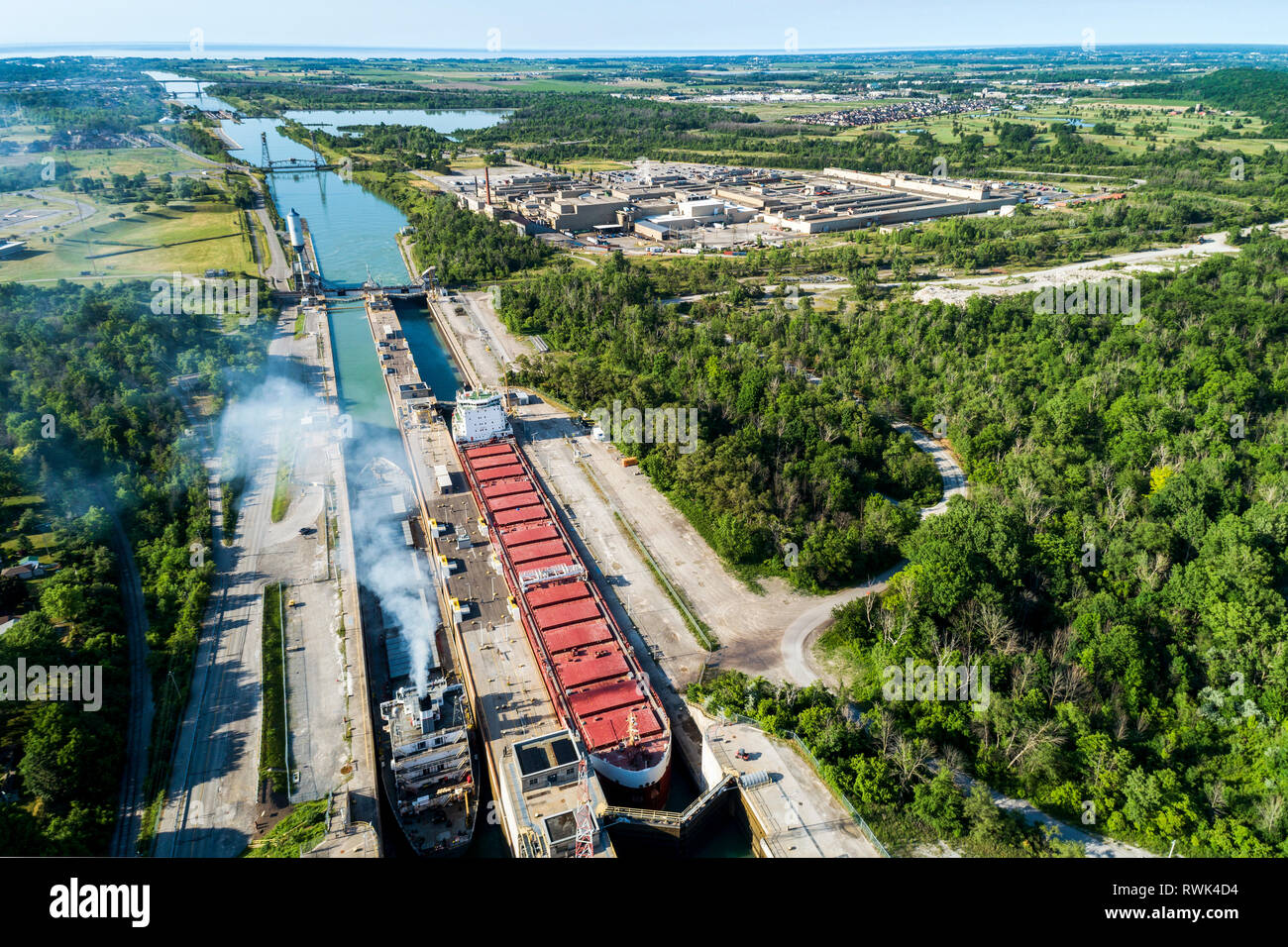 Aerial view of two large laker ships in a canal's lock system; Thorold, Ontario, Canada Stock Photo