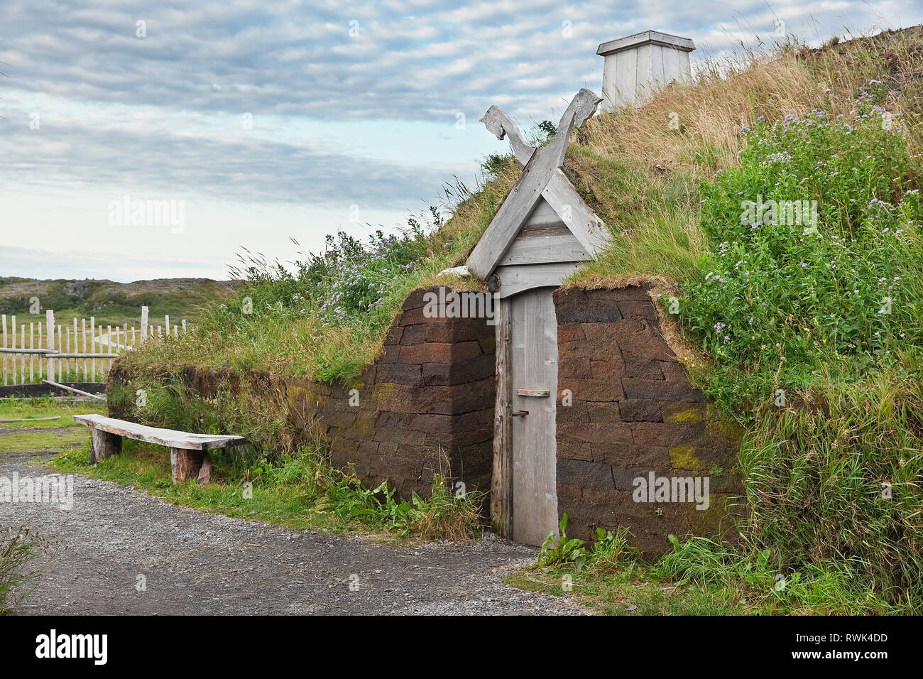 Entrance to a recreated Viking longhouse with its characteristic sod roof and peat block walls. L'Anse aux Meadows National Historic Site, L'Anse aux Meadows, Newfoundland, Canada Stock Photo