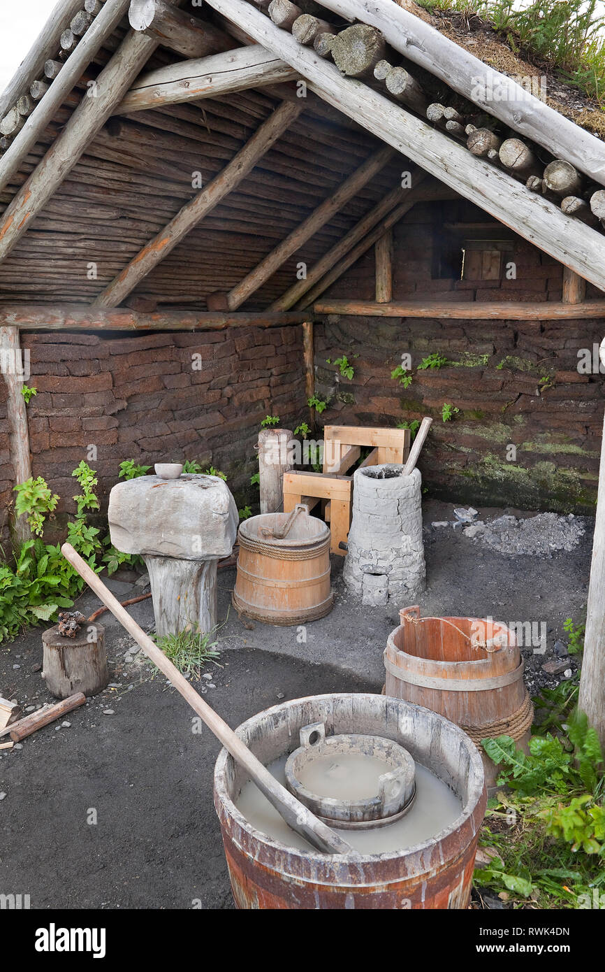 Recreation of a Viking era smelting hut with a stone and clay furnace, and various implements for producing iron from bog ore. L'Anse aux Meadows National Historic Site, L'Anse aux Meadows, Newfoundland, Canada Stock Photo