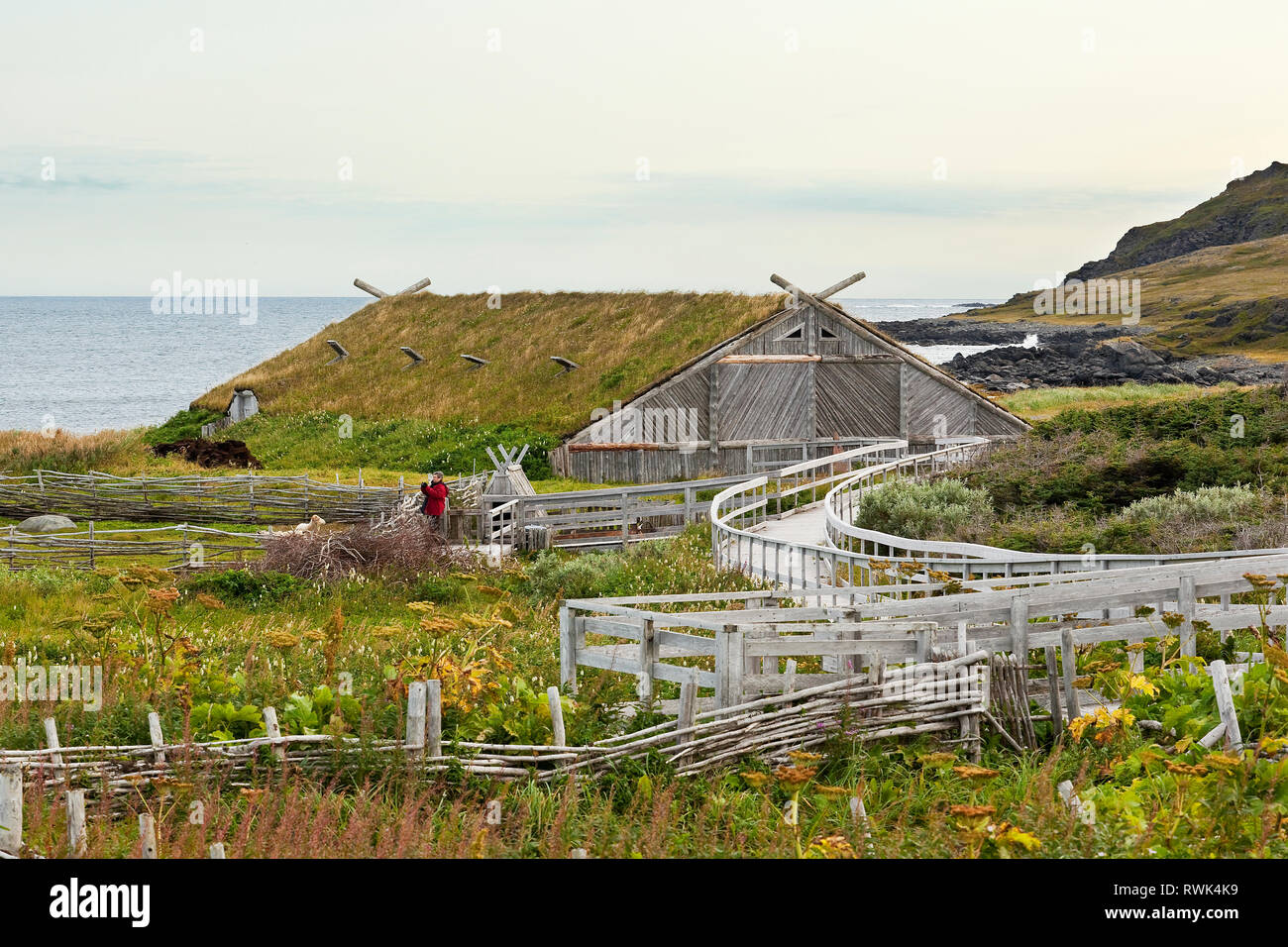 Sod-covered building, fenced-in garden and sheep enclosure at Norstead Viking Village and Port of Trade, L'Anse aux Meadows, Newfoundland, Canada Stock Photo