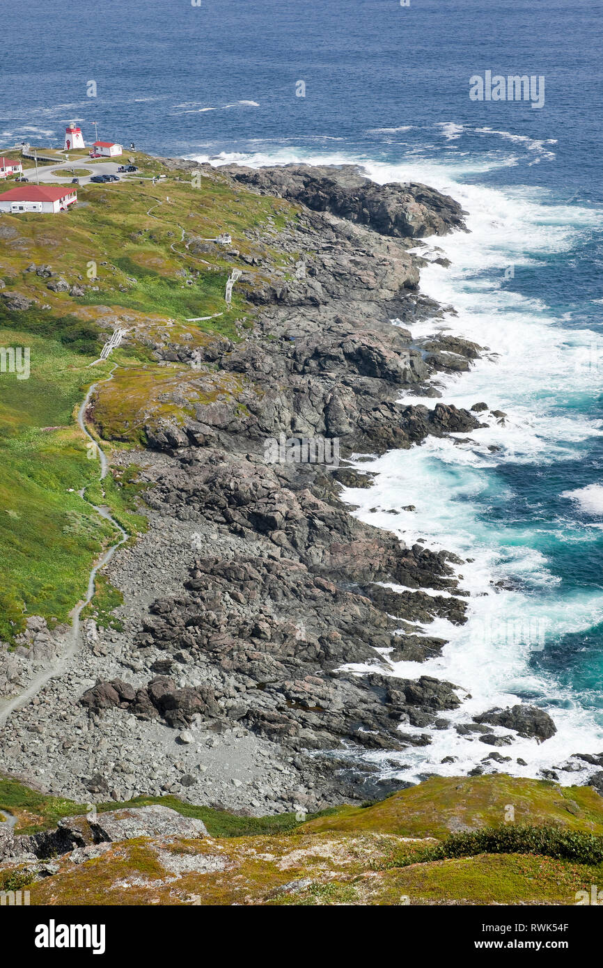Rugged shoreline, trail and lighthouse at Fishing Point Municipal Park as seen from Daredevil Hill, St. Anthony, Newfoundland, Canada. Stock Photo