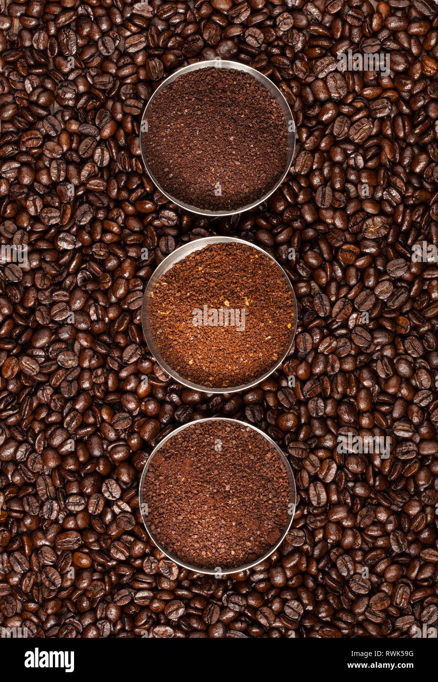 Overhead view of three varieties of ground coffee beans on a roasted